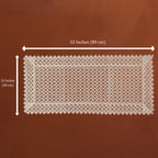 A rectangular cream lace doily with a detailed floral border and openwork center, shown on a brown background with dimension lines indicating 32 inches by 16 inches.