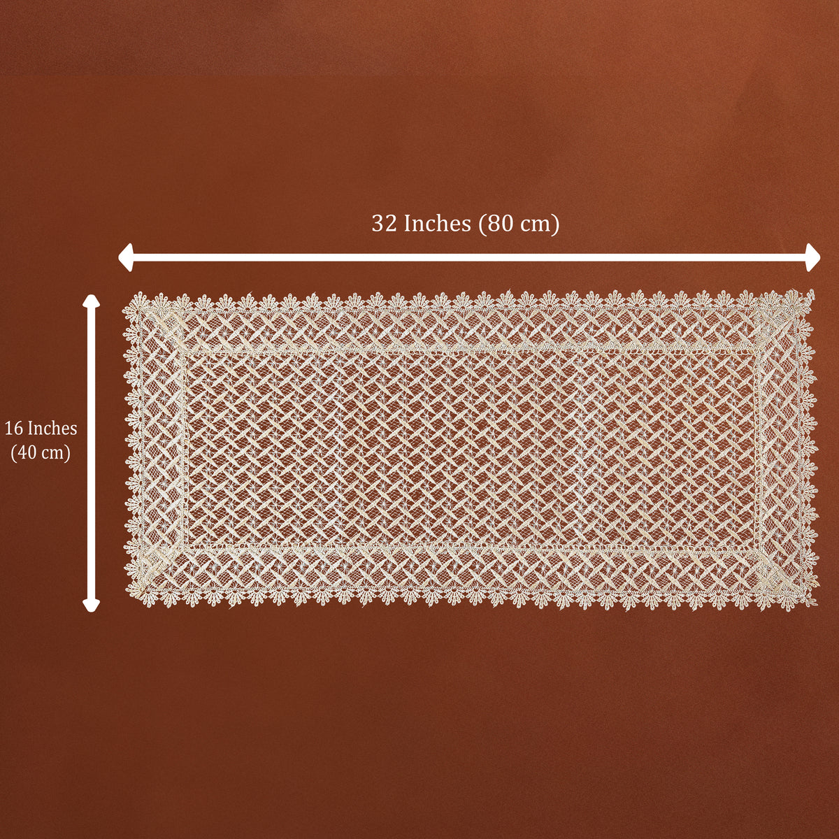 A rectangular cream lace doily with a detailed floral border and openwork center, shown on a brown background with dimension lines indicating 32 inches by 16 inches.