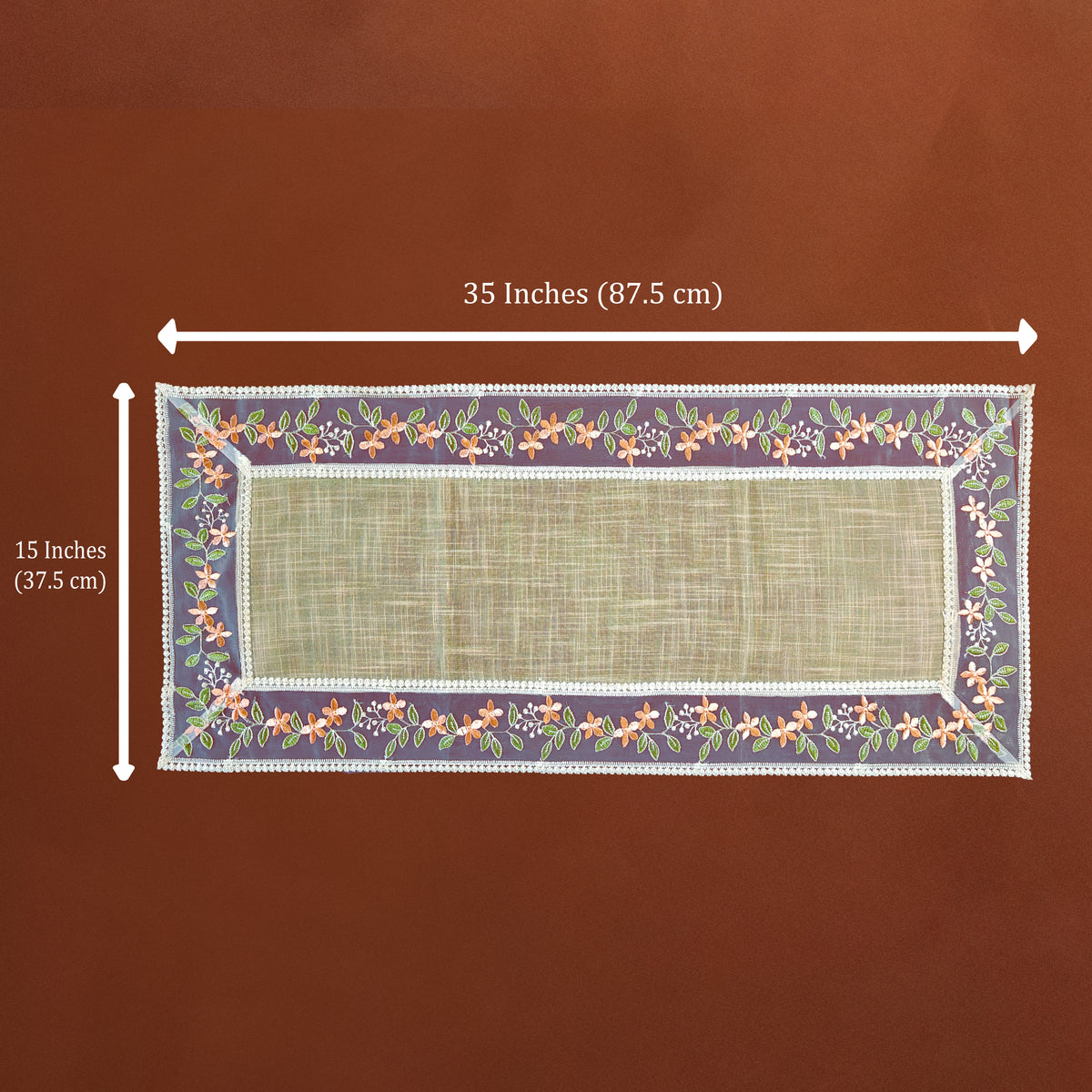 A rectangular woven placemat with a floral border and white trim, shown on a brown background with white dimension arrows indicating 35 inches by 15 inches.