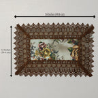 A rectangular lace placemat with a floral printed center and brown lace border, shown on a light background with dimension arrows indicating 16 inches by 12 inches.