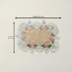 A rectangular lace doily with a beige center and pink floral embroidery around the border, shown with black dimension arrows and text indicating 18 inches by 12 inches.