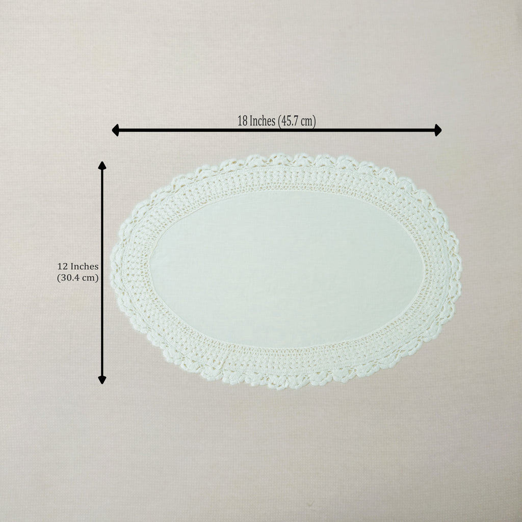 An oval white crocheted lace doily with dimension arrows and text indicating a width of 18 inches (45.7 cm) and a height of 12 inches (30.