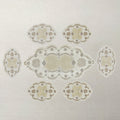 Decorative lace pattern table runner with 6 table mats table on a light background