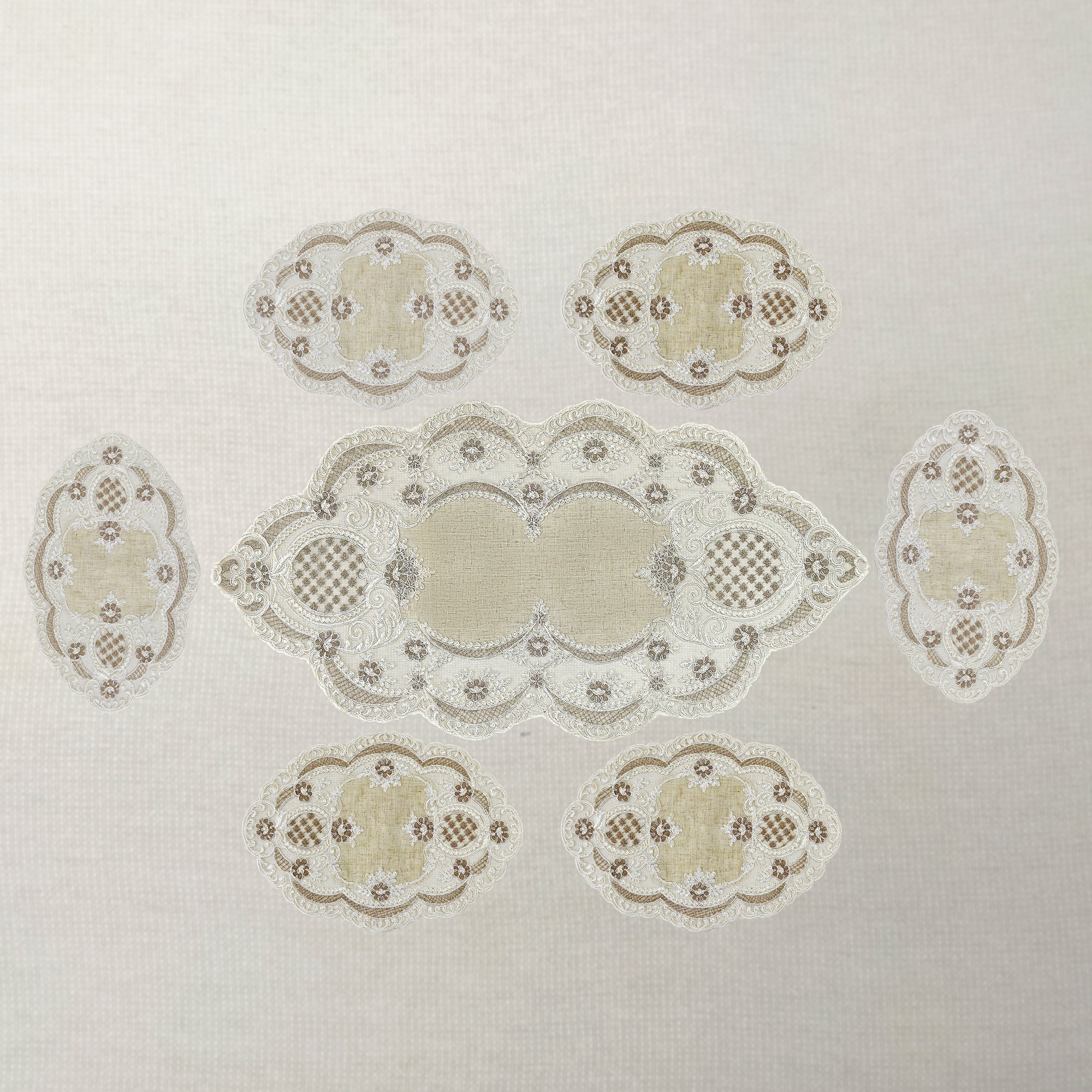 Decorative lace pattern table runner with 6 table mats table on a light background