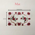 An embroidered floral mat shown on a light neutral background with dimension arrows and text indicating 16 inches by 12 inches.