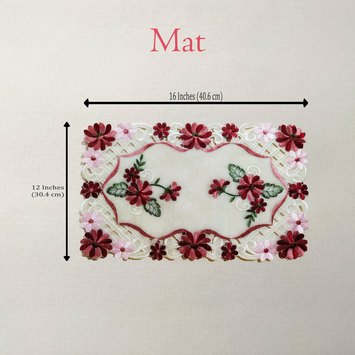 An embroidered floral mat shown on a light neutral background with dimension arrows and text indicating 16 inches by 12 inches.
