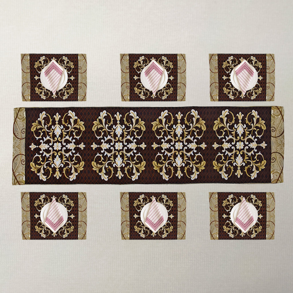 A set of table linens including a long runner and six placemats, featuring ornate gold and white baroque-style damask patterns.