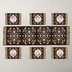 A set of table linens including a long runner and six placemats, featuring ornate gold and white baroque-style damask patterns.