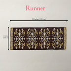 A rectangular decorative runner with an ornate repeating damask-style pattern in dark brown, gold, and white, shown on a light neutral background with printed dimension arrows indicating 52 inches by 12 inches.